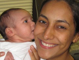 San Diego kickboxer Gina Reyes holds her new baby girl at the gym.